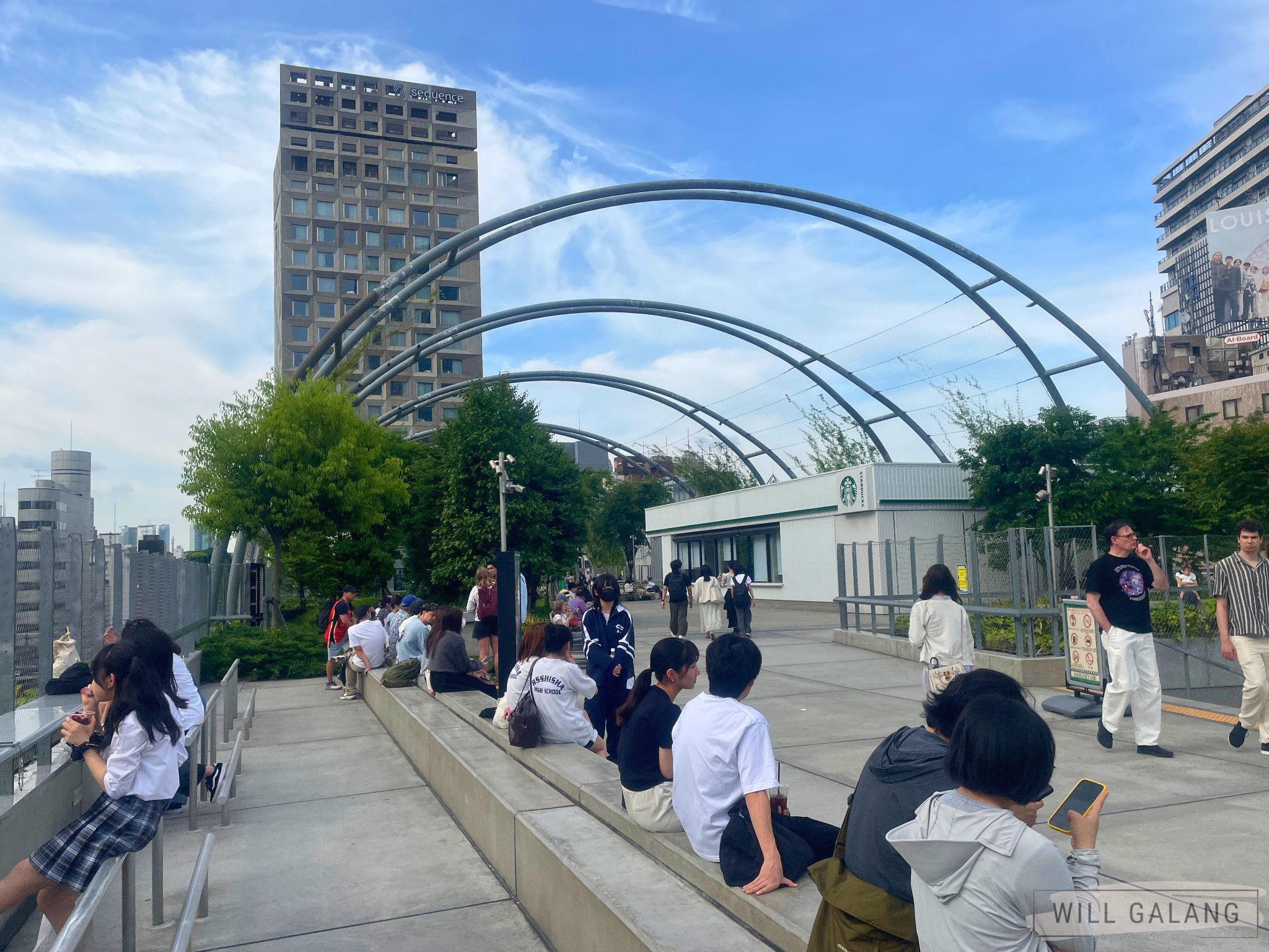 A lazy afternoon at Shibuya’s Miyashita Park, where city views, summer skies, and casual conversations blend seamlessly above the bustling streets below.